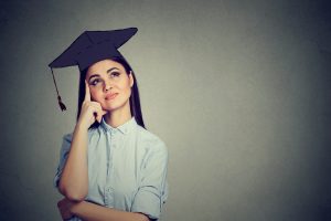 Woman wearing a graduation hat wondering how to become smarter