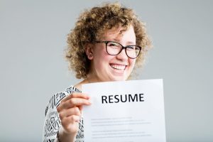 A woman holding her CV with her skills on it