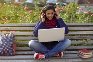 Girl on laptop mastering a new language fast