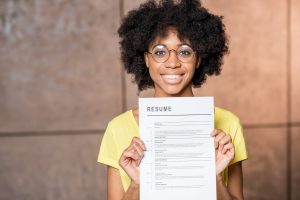Woman holding up resume showing her social media accounts updated