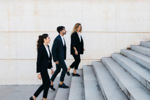3 people in suits walking up steps hoping to boost their skill set