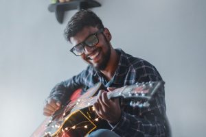 Happy man playing music on an instrument